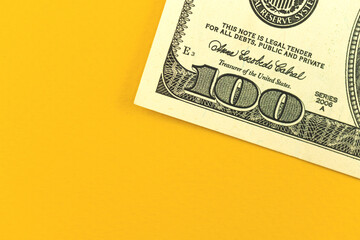 Business deposit concept, office table with money, close-up of US 100 dollar bill on yellow background, top view photo