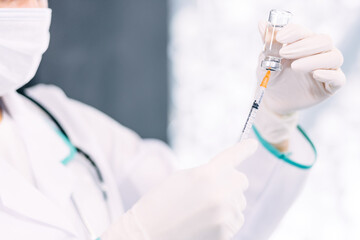 COVID-19 vaccine in researcher hands, female doctor holds syringe and bottle with vaccine for...