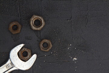Wrench nuts and bolts on black background	. Close up. 
