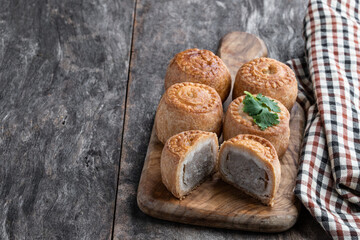 Mini Melton Mowbray pork pies on rustic wooden table