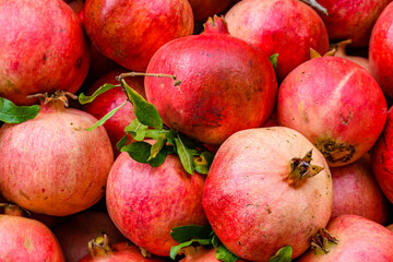 Many pomegranates for sale at the market. Fruit background
