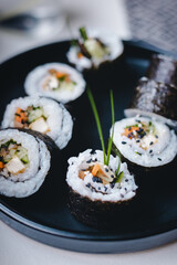 Vegan vegetarian sushi roll on the black plate