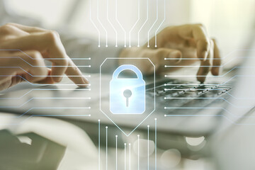 Double exposure of creative lock hologram with chip and hands typing on laptop on background....