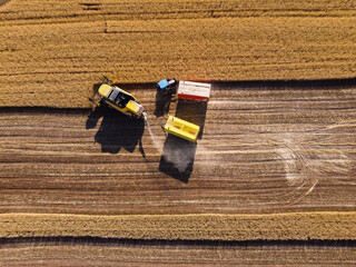 Harvesting machine working in the field. Top view from the drone Combine harvester agricultural...
