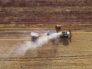 Harvesting machine working in the field. Top view from the drone Combine harvester agricultural...