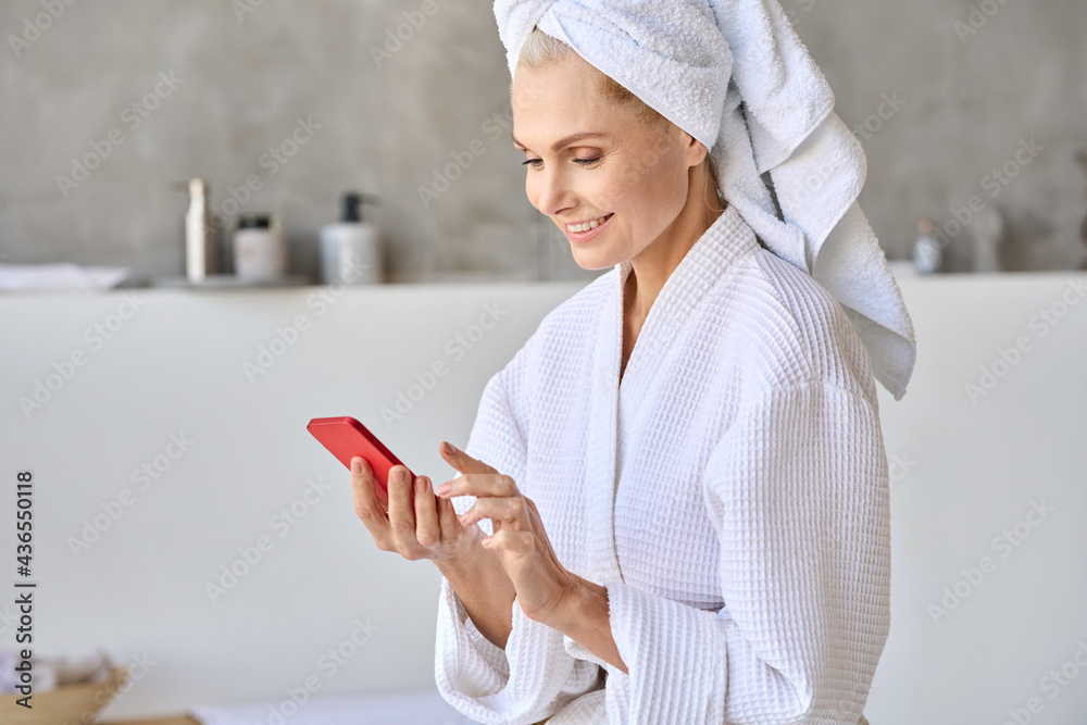 Poster portrait of happy smiling gorgeous middle aged lady wearing bathrobe and turban towel on head using 