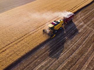 Harvesting machine working in the field. Top view from the drone Combine harvester agricultural...