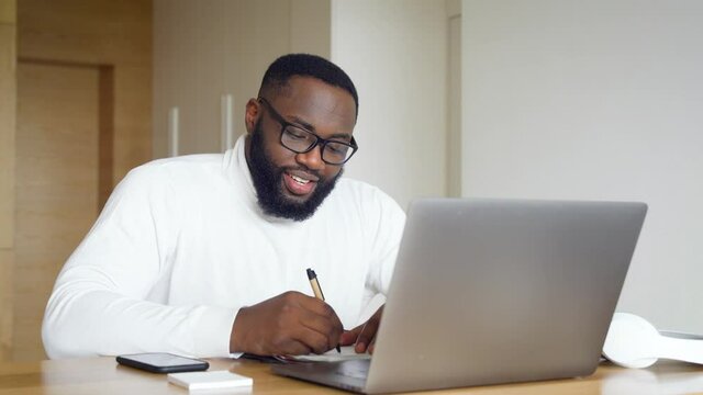 Smiling african american male teacher conducting online lesson or webinar