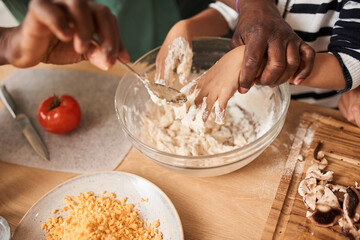 Father teaching and cooking together with his daughters and doing bakery