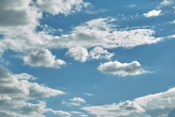 Obraz premium Blue sky background with illuminated clouds. Natural texture after rain sky. Summer background concept