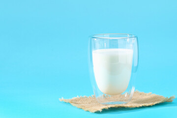 Glass of milk on a blue background. Milk products.