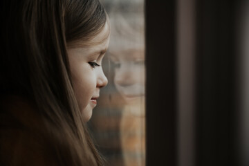 photo of a girl looking out the window