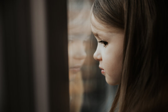 photo of a girl looking out the window