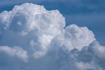 Naklejka na ściany i meble Huge cumulus cloud in summer sky