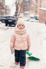 portrait of a tired or upset little girl asking her parents for a winter walk