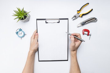 construction planning work concept. above view. blank clipboard, wooden planks and tools on table....
