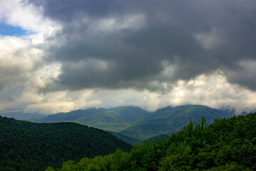 Naklejka premium dark clouds over the mountains