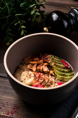 Raw linen cereal with fruits, nuts in bowl. Super food for healthy nutritious breakfast