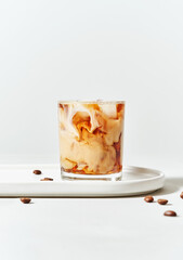 Iced cold brew coffee with coconut milk in glass on white background with copy space. Menu mockup. Summer cold refreshing drink concept.