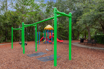 Fototapeta na wymiar Colorful playground in a neighborhood for kids to enjoy