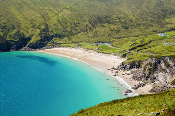 Keem beach, Achill island in county Mayo, Ireland, warm sunny day. Clear blue sky and water of the Atlantic ocean.