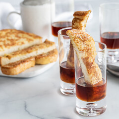 Close up of French toast shot glass appetizers with maple syrup ready for eating.