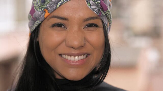 young beautiful indian woman wearing a traditional turban smiles at the camera