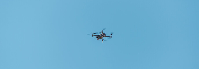 Drone flying in the blue sky.