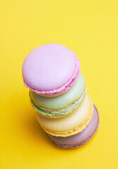 Colored macarons on a yellow