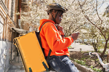 Man courier using a map app on mobile phone to find the delivery address