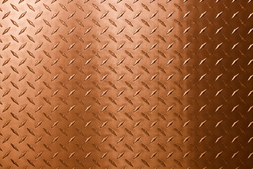 Abstract background of copper texture with a diamond pattern.