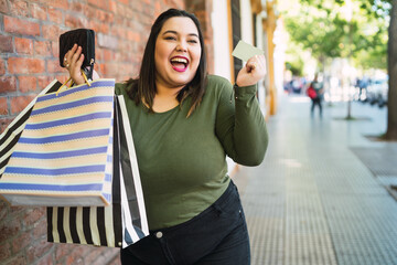 Young woman doing shopping with credit card.