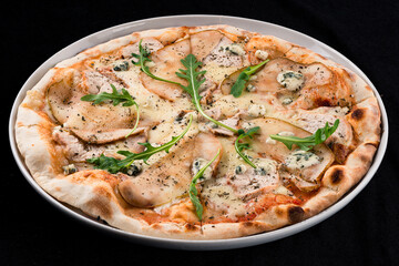 Pizza with pears and Gorgonzola cheese on a wooden background