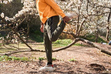 Man stretching after exercise outdoors at spring park