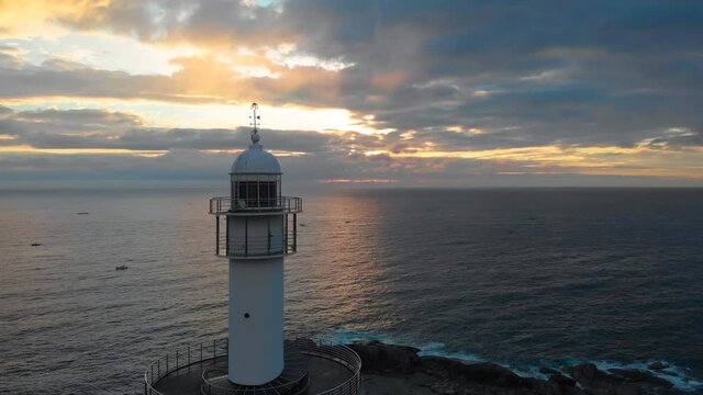 Lighthouse at sunrise of east coast sea of Korea. Sun is gold and clouds are turning golden. Beautiful nature and landmark aerial drone footage took with 4K 30fps.