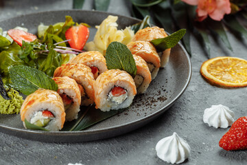 Maki Sushi - a roll of cream cheese, strawberries, avocado and fried salmon. Summer seasonal sushi rolls