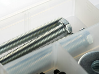Closeup shot of lag screws on a plastic container