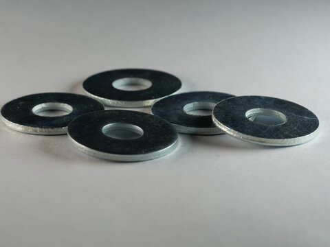 Closeup shot of flat washers isolated on a white surface