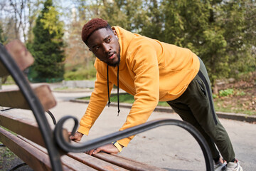 Athletic guy preparing to the body workout with concentration