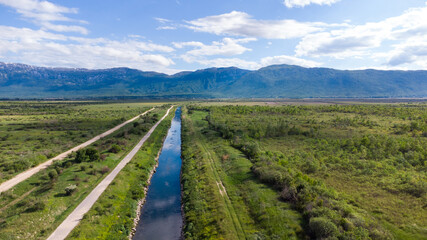 Fototapeta na wymiar Aerial drone view of Irrigation channel in the field. Drainage River channel in nature. 