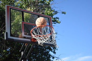 basketball mid air over hoop