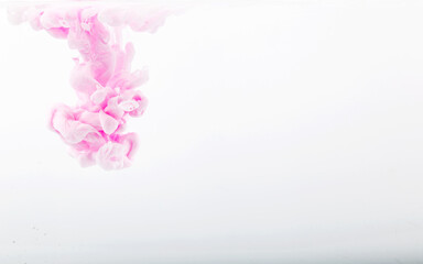 Obraz premium Color drop in water, photographed in motion. pink ink in water isolated on white background. Background and texture.