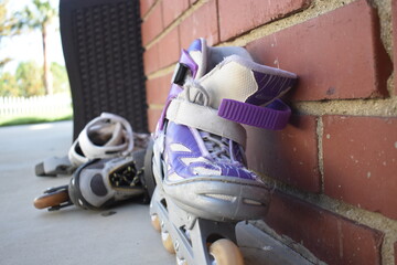 roller blades against brick wall