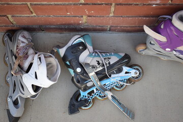 roller blades against brick wall
