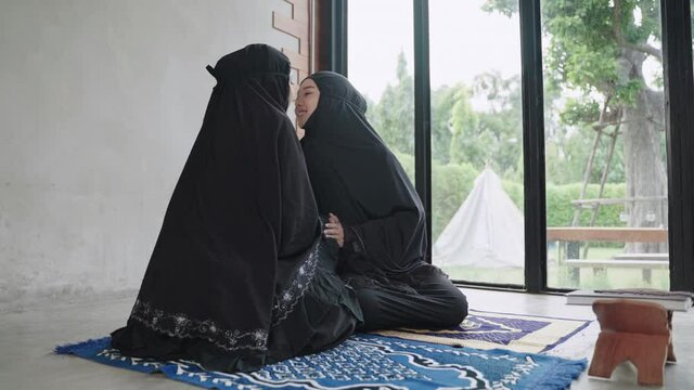 50p frame rate footage of young Muslim women are doing prayers for the blessing of God Allah.
