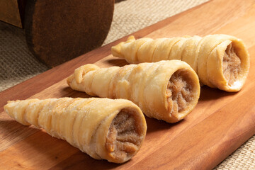 Delicious cone of dulce de leche (canudinho), selective focus.