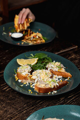 Woman is eating tortillas with hands, no face, hands only visible