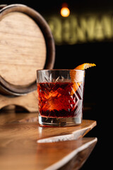 Beautiful and posh photo of negroni cocktail for a mixology magazine cover, close up, dark atmosphere