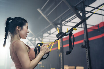 Fototapeta na wymiar Athlete sport girl workout hold rope exercise in fitness gym stadium