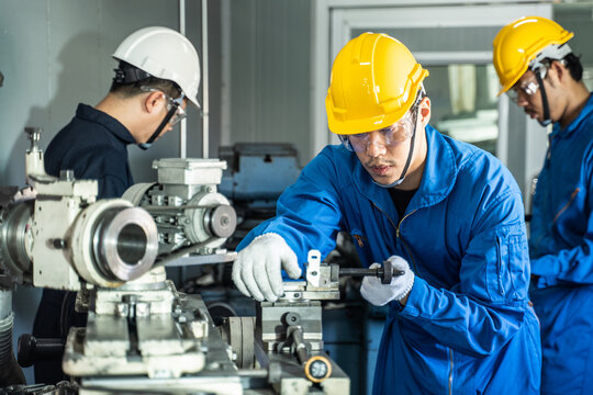 Mechanical technician industrial worker team work on milling machine